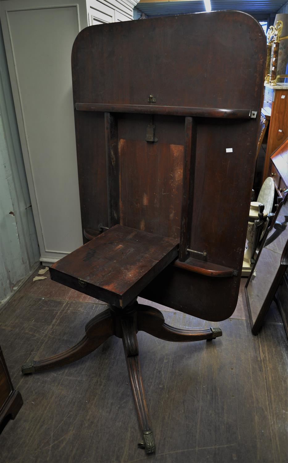 A 19TH Century mahogany dining table raised on quatrefoil base terminating on casters. - Image 2 of 2