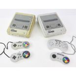 2 SNES - Super Nintendo Entertainment System Consoles. This lot contains two SNES consoles,