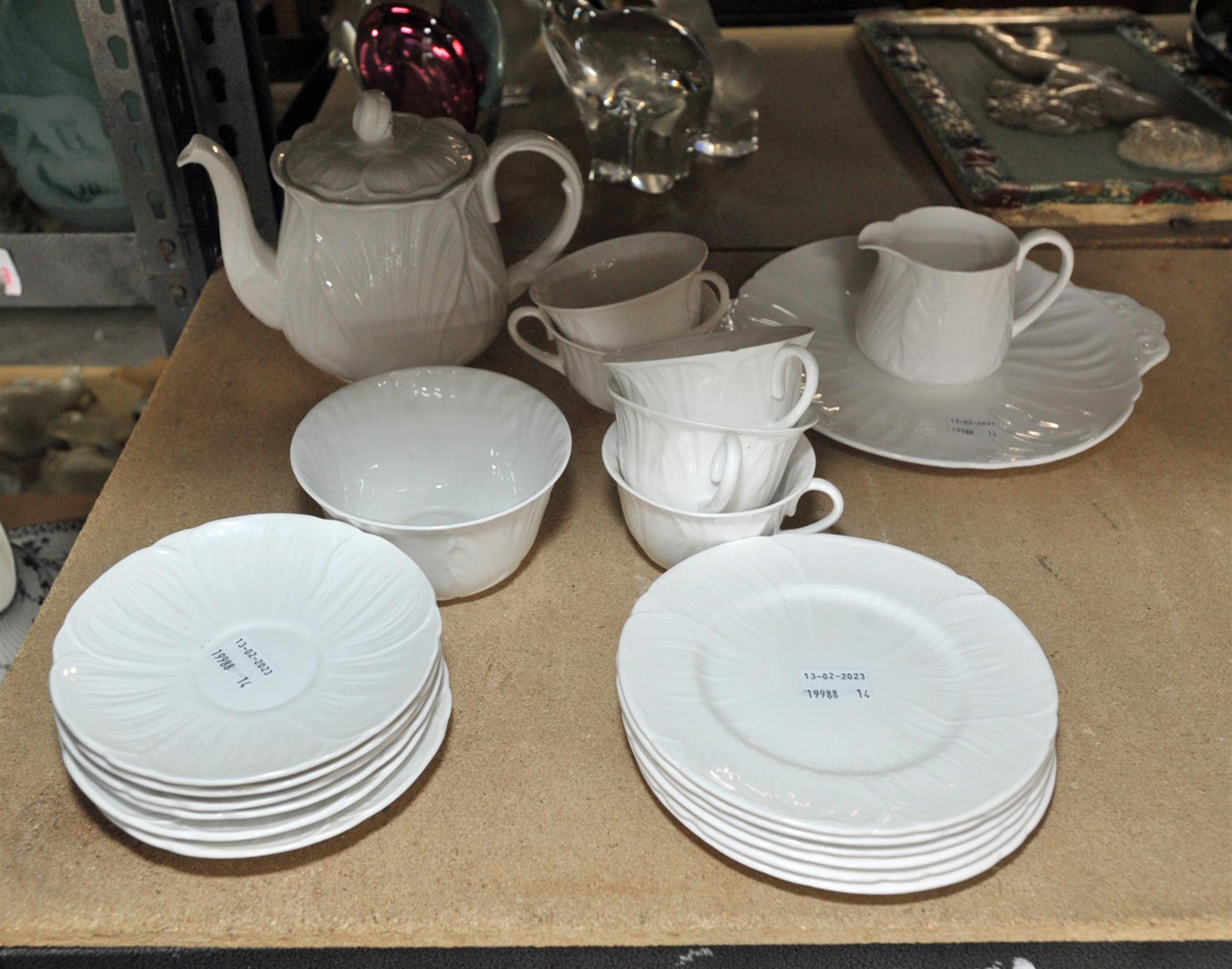 A Shelly white porcelain tea set, moulded with leaves, to comprise tea pot and cover, milk jug,