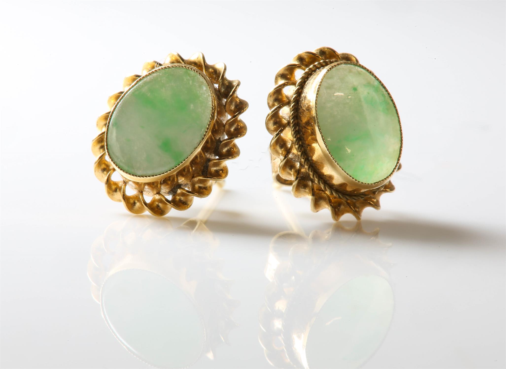 A pair of stamped 9ct yellow gold set earrings with oval jade to centre, post and butterfly fittings