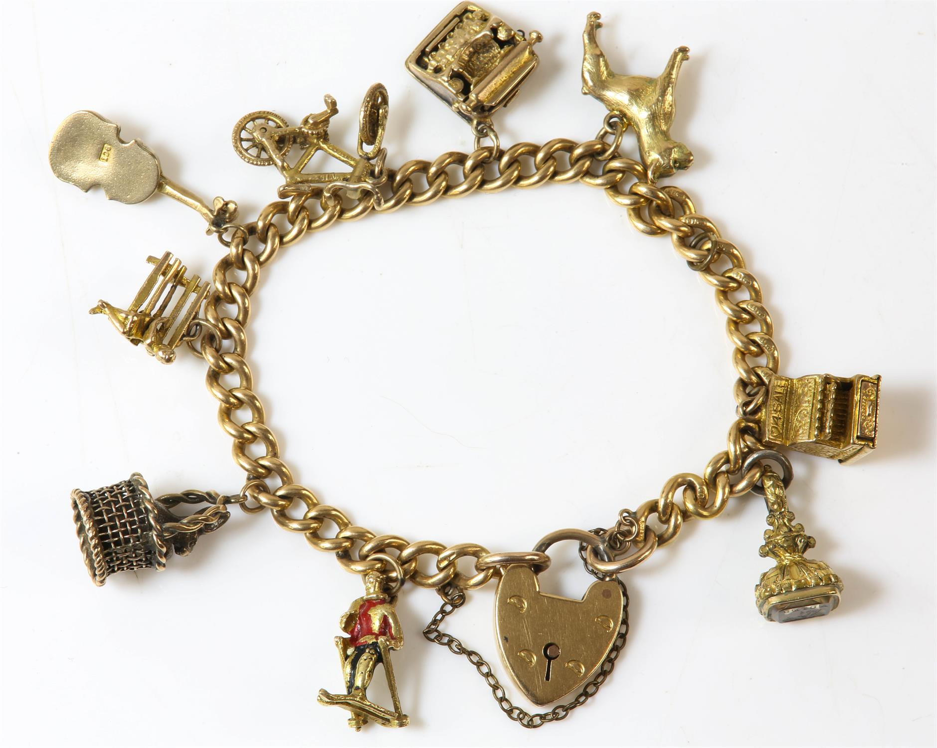 Curb link charm bracelet with heart padlock clasp, in 18ct yellow gold, with eight charms in 9ct