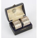 Two Silver napkin rings with ribbed decoration. Marks for Birmingham 1922 maker Docker and Burn Ltd,
