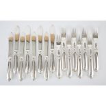 Set of eight fish knives and forks with shell and scroll ends by Mappin & Webb, Sheffield 1975, 35.