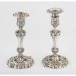 Two foliate cast silver candlesticks engraved with a Stag crest, by S C Younge & Co, Sheffield 1818,