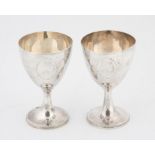 Pair of George III silver goblets each with oval bright cut blank cartouche and beaded foot rim by