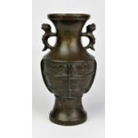 A Chinese bronze archaistic hu with mythological animal handles and lappet shaped motifs on the