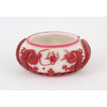 A Beijing glass, single red overlay brushwasher or bowl, decorated with dragons confronting a