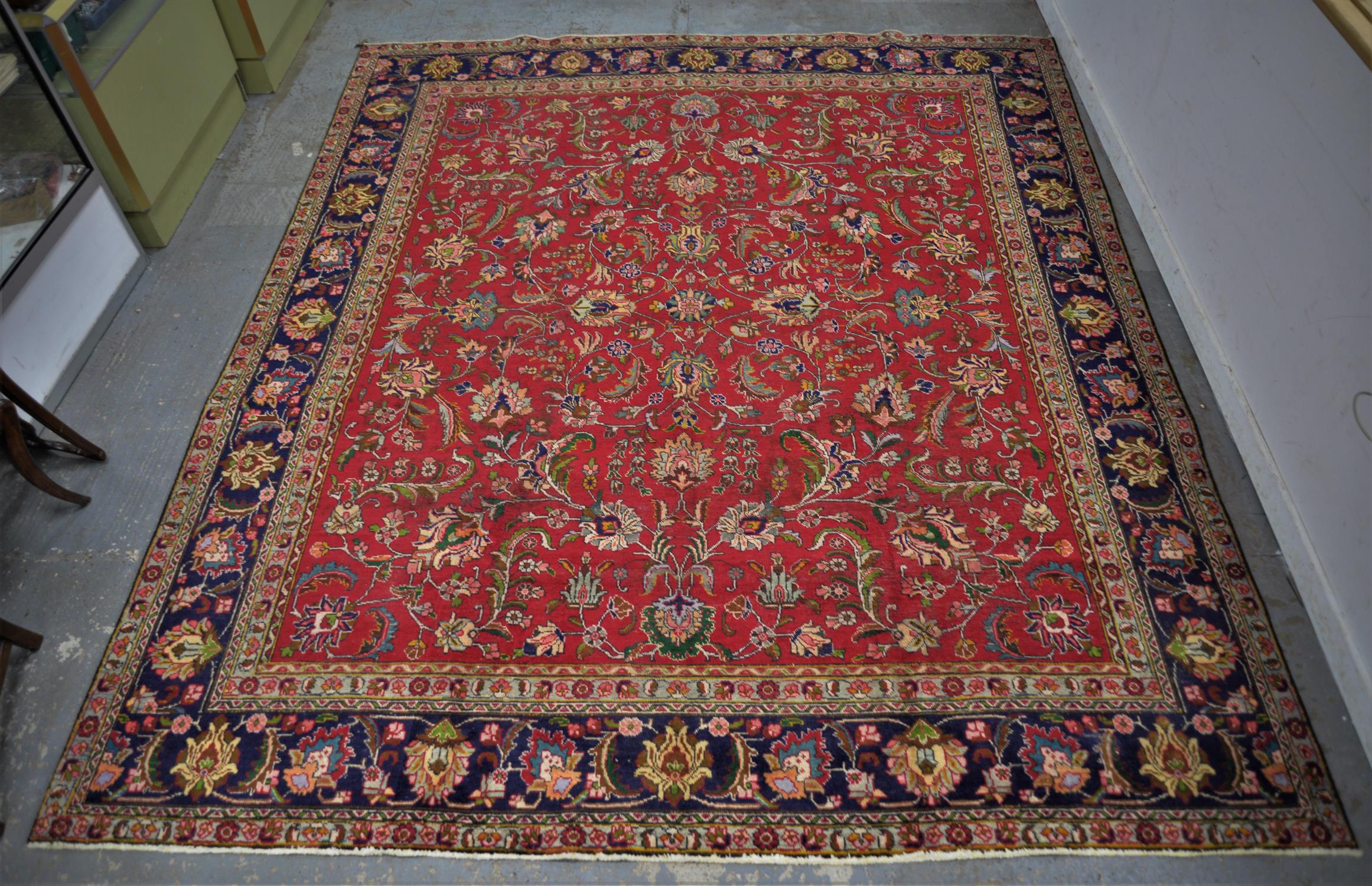 A Vintage red ground Persian Tabriz rug foliate field with blue borders. - Image 3 of 3