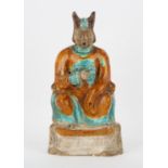 A glazed ceramic, Fahua [or other] figure of a seated scholar; decorated with ochre,