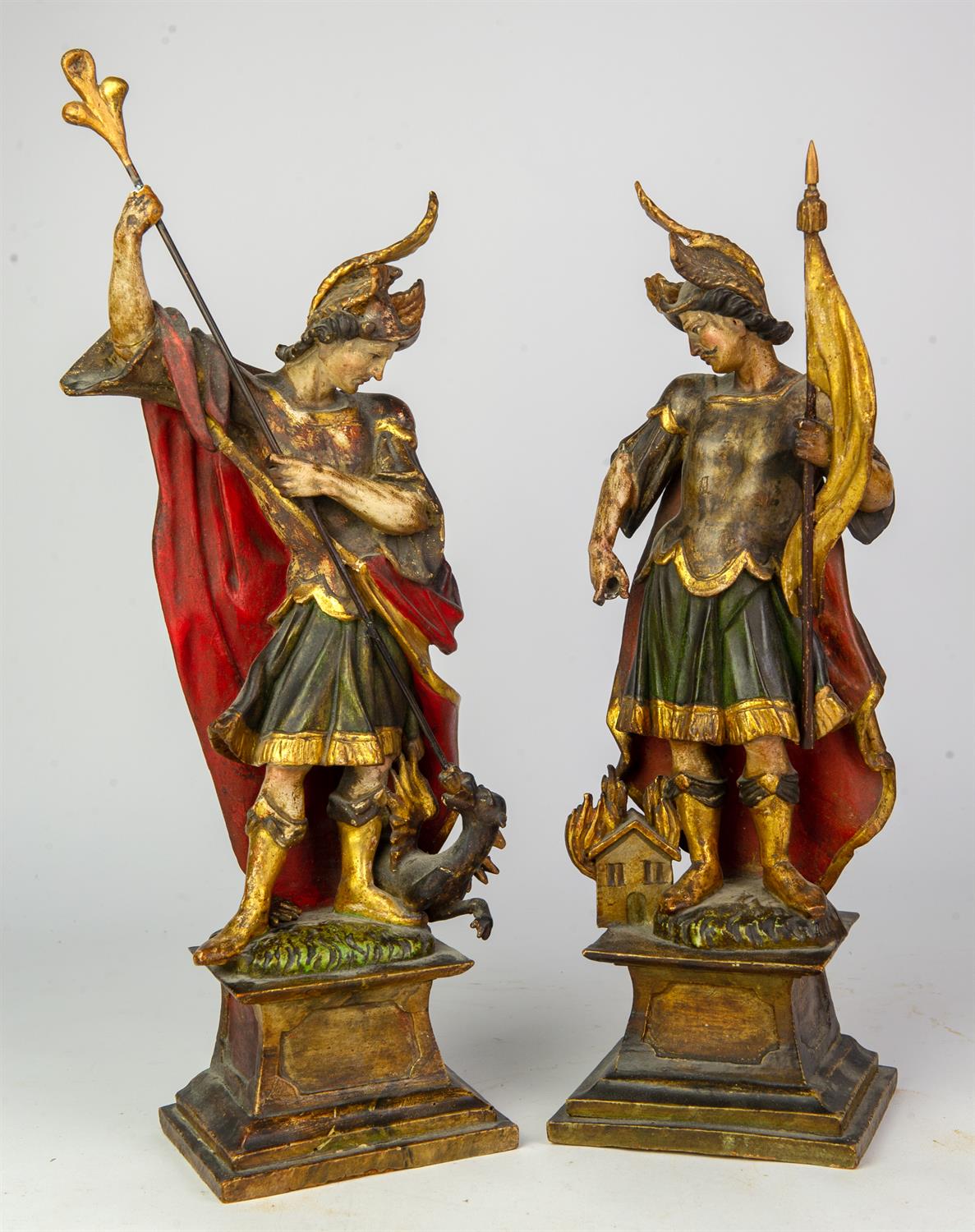 A pair of Continental carved and decorated wood figures of Saint George and Saint Florian,