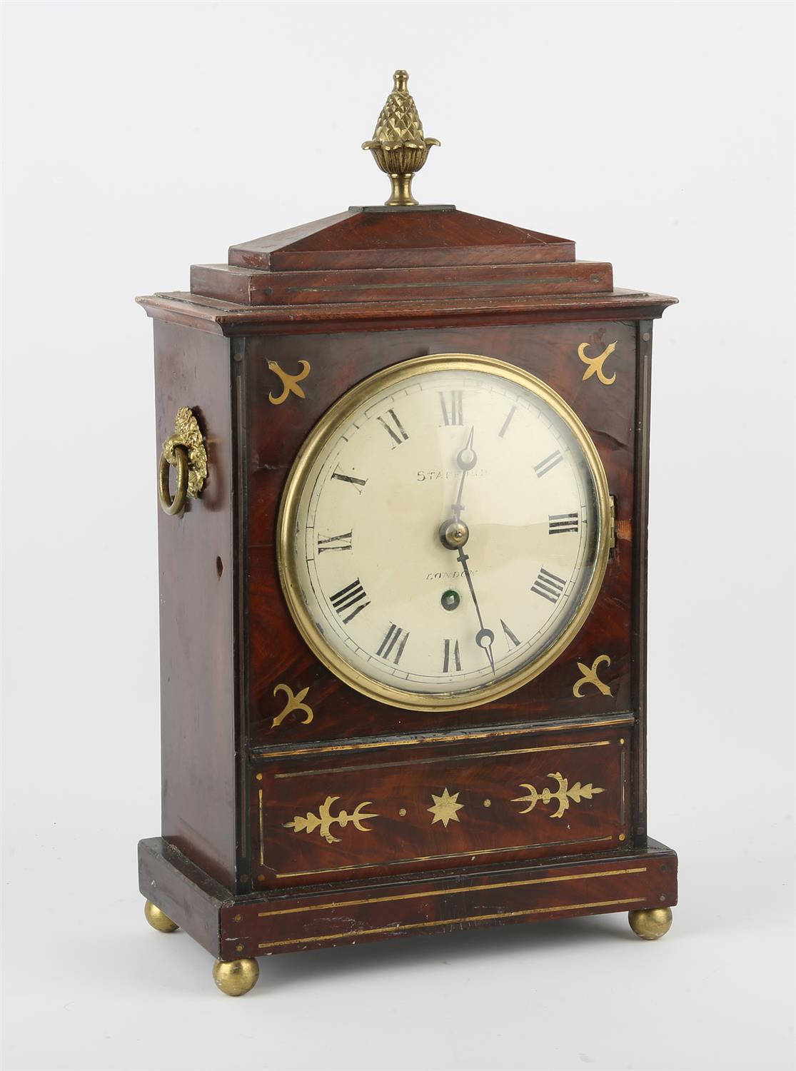 Regency mahogany and brass inlaid mantle clock, the white enamel dial signed Stafford. London.