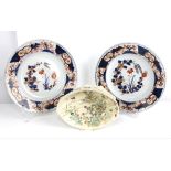 A pair of Japanese Imari dishes; each one decorated in underglaze blue, orange -red and gilt with