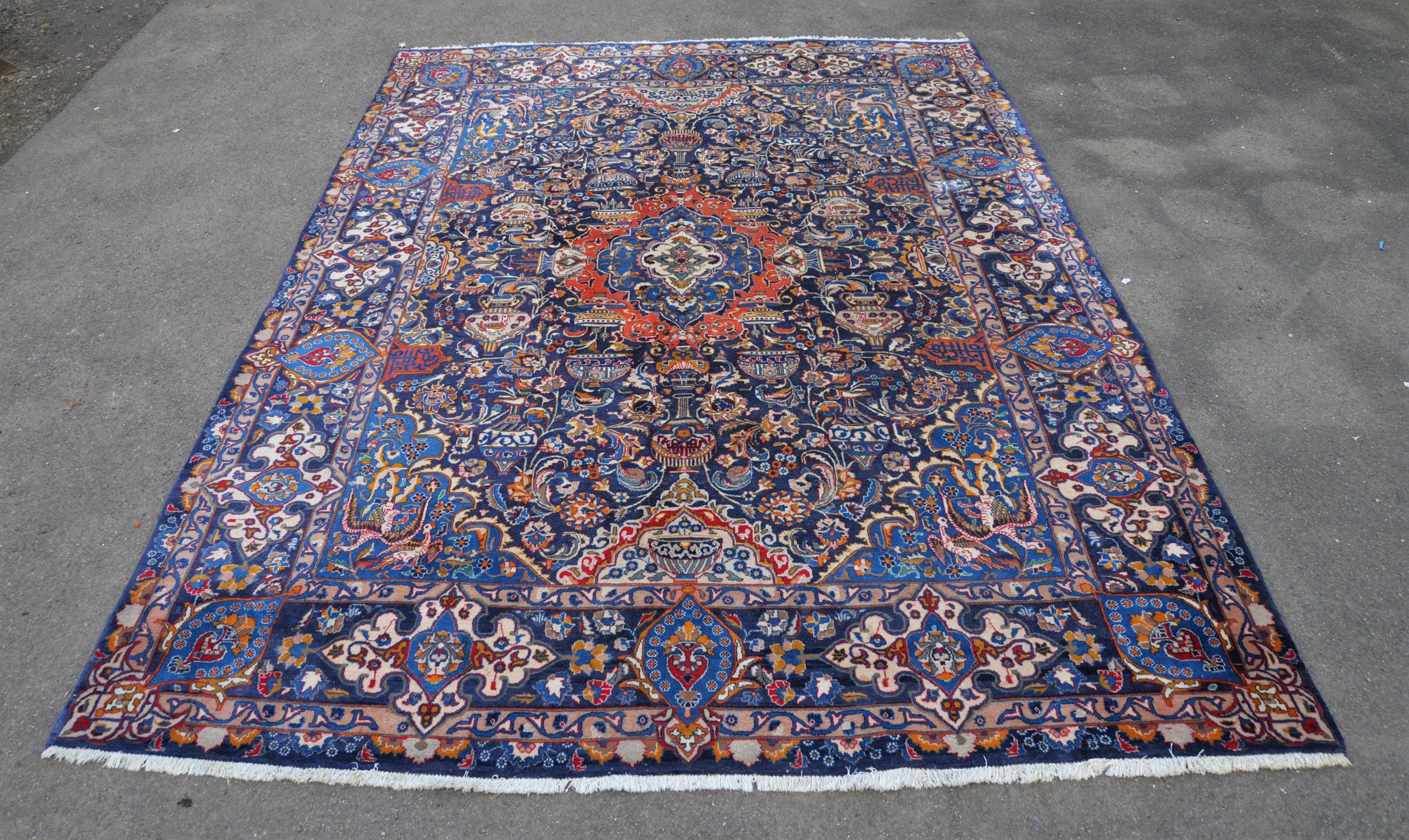 Persian Wool carpet, 20th Century, with central floral lozenge, with an overall design of cups,