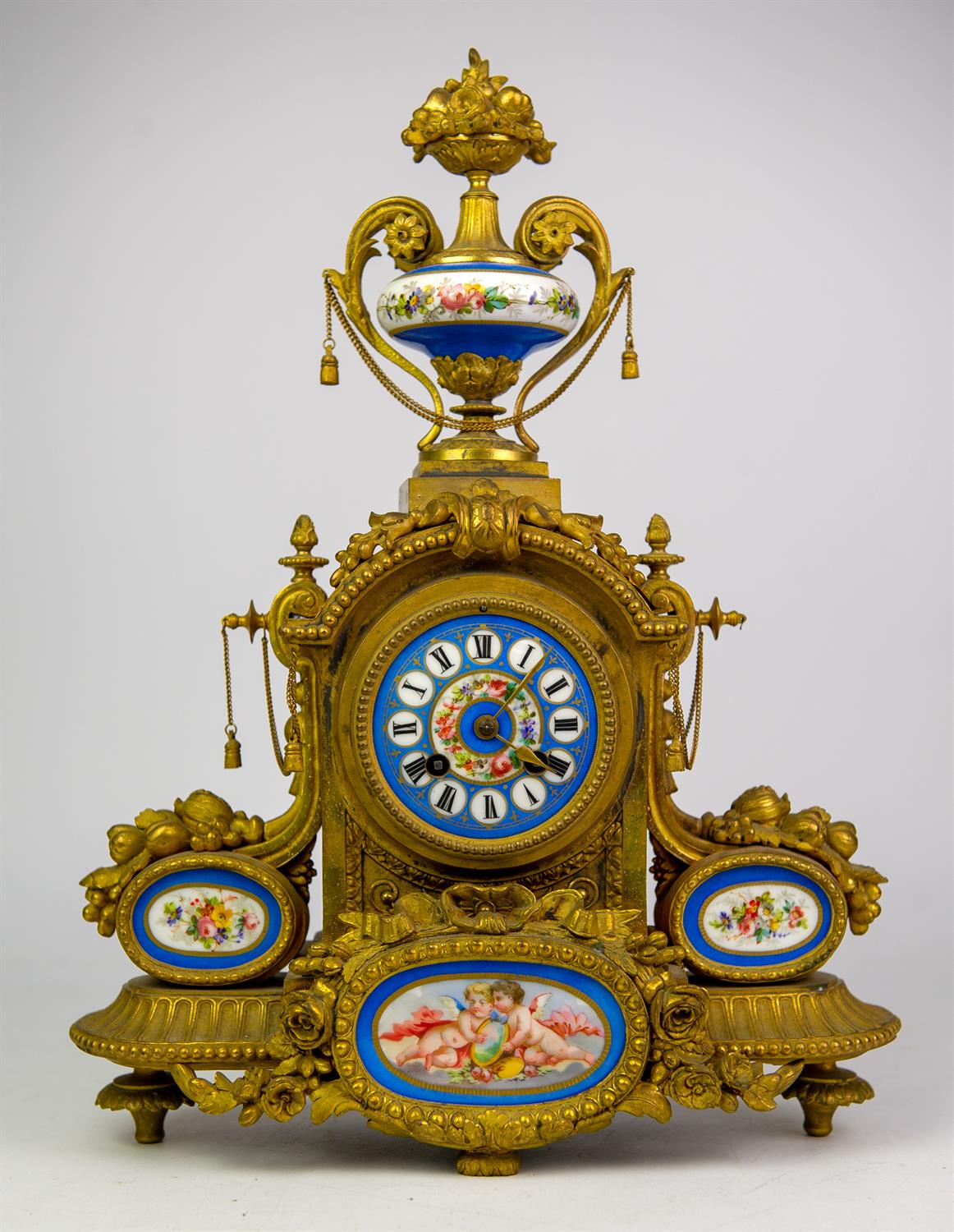 French spelter and Sevres style porcelain mantel clock, 19th Century, the case with urn finial and