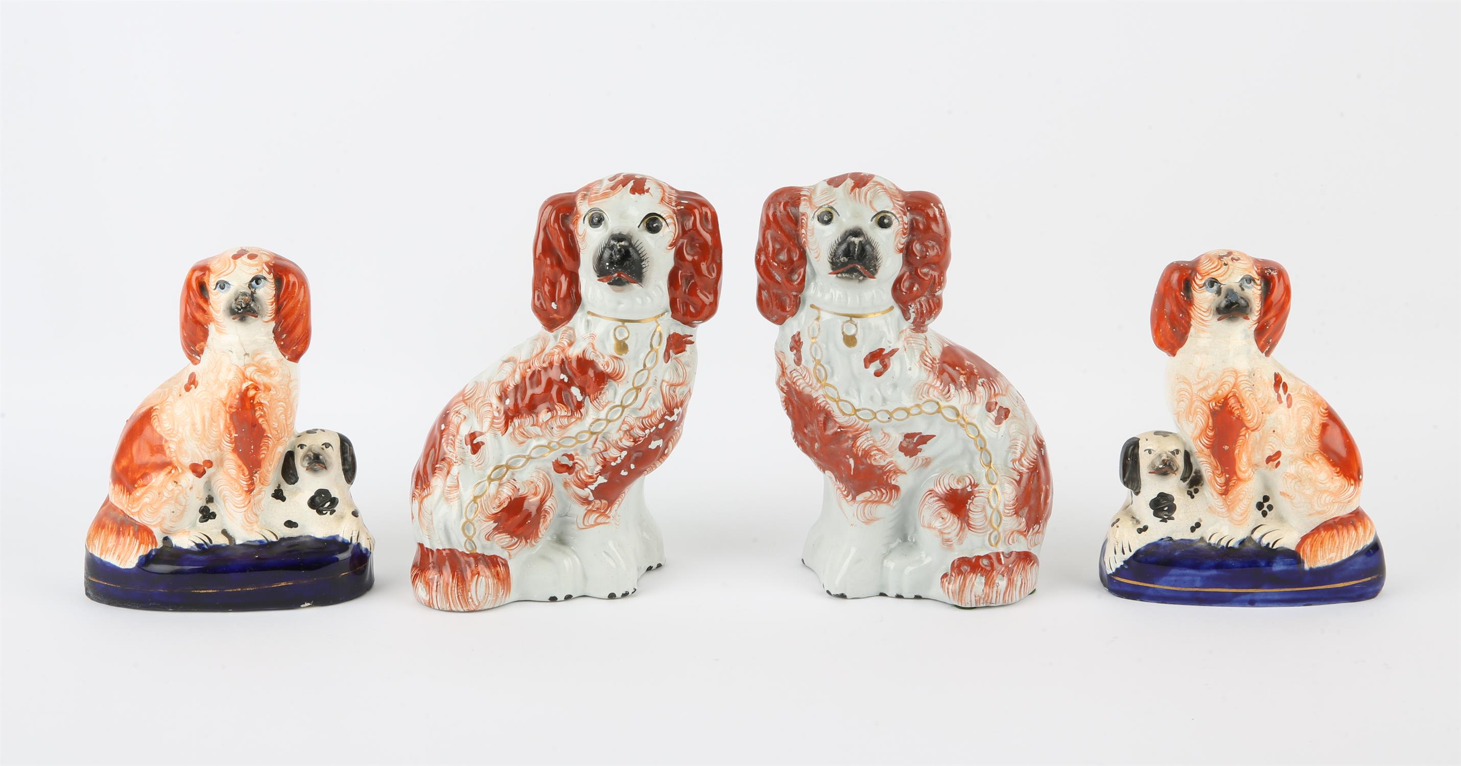 Pair of Staffordshire dogs, 19th Century, modelled seated, coloured with red splash decoration,