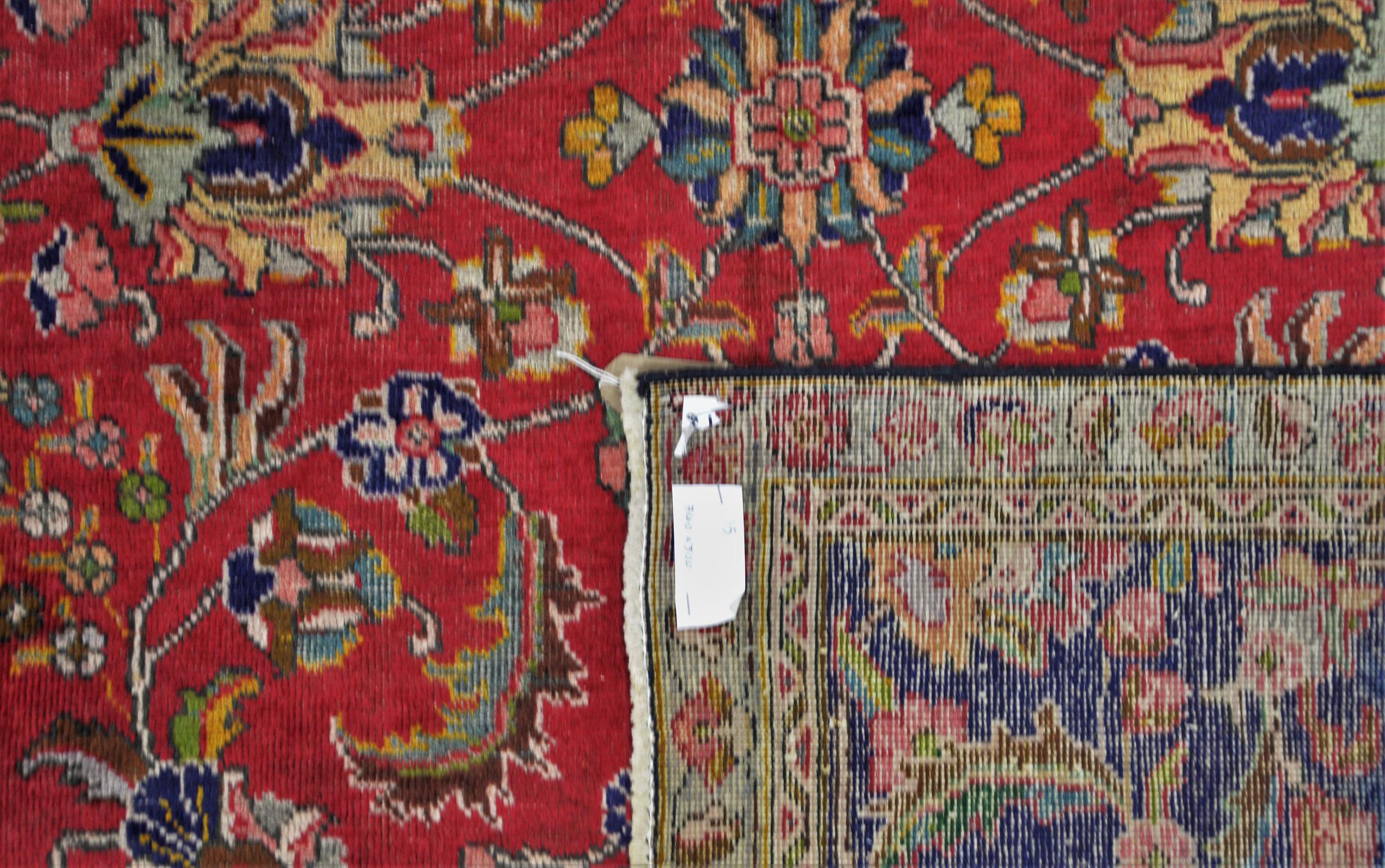 A Vintage red ground Persian Tabriz rug foliate field with blue borders. - Image 2 of 3