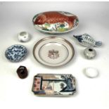 A famille rose armorial shallow soup dish with central arms of The East India Company above the