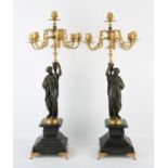 Pair of French bronze and gilt bronze six light candelabra, late 19th Century, in the form of two