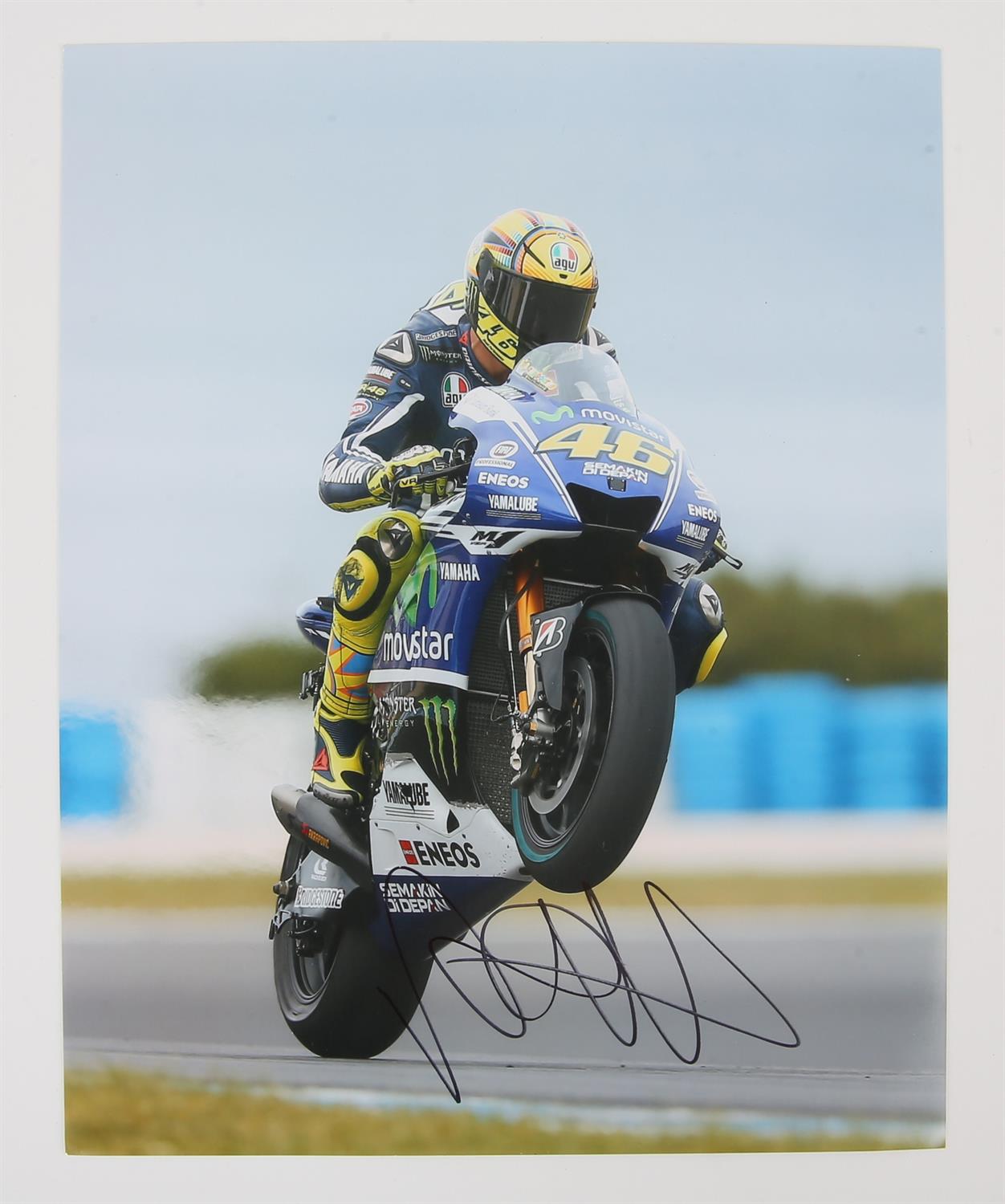 Valentino Rossi.- Autographed colour photograph, signed in black ink by former Italian