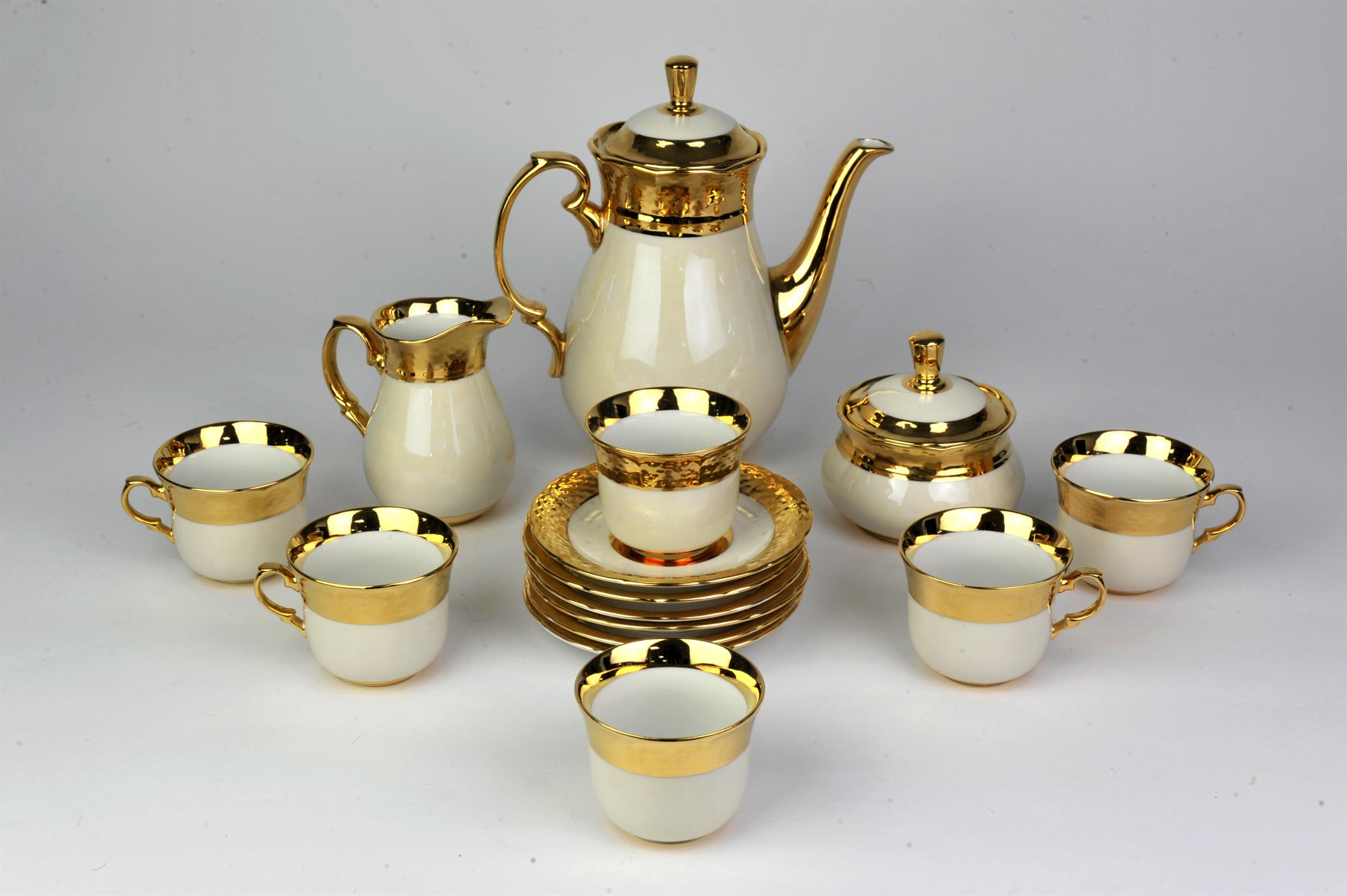 Continental porcelain coffee set, 20th Century, with gilt band decoration, to comprise coffee pot