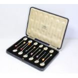 Cased set of 12 silver spoons each with a different colour geometric design stone by Ward G