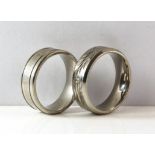 Two Titanium rings size X and Y respectively.