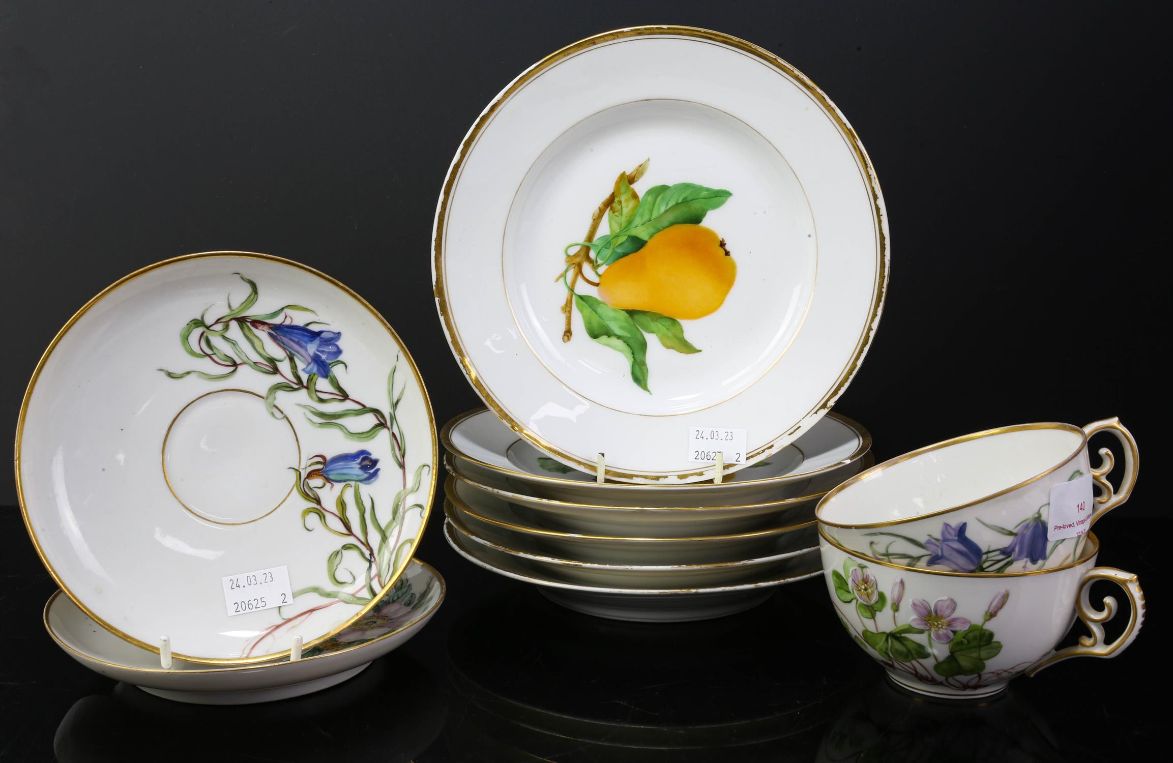 Royal Copenhagen Two teacups six plates decorated with fruit.