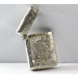 Novel Edwardian bark effect silver vesta case with two flowers to front and large embossed flower