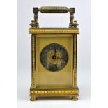 A Brass cased carriage clock, with Arabic numeral chapter ring, key to back of case,