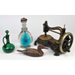 Three vintage sewing machines, silver plated teapots, decanter and a brass candlestick.