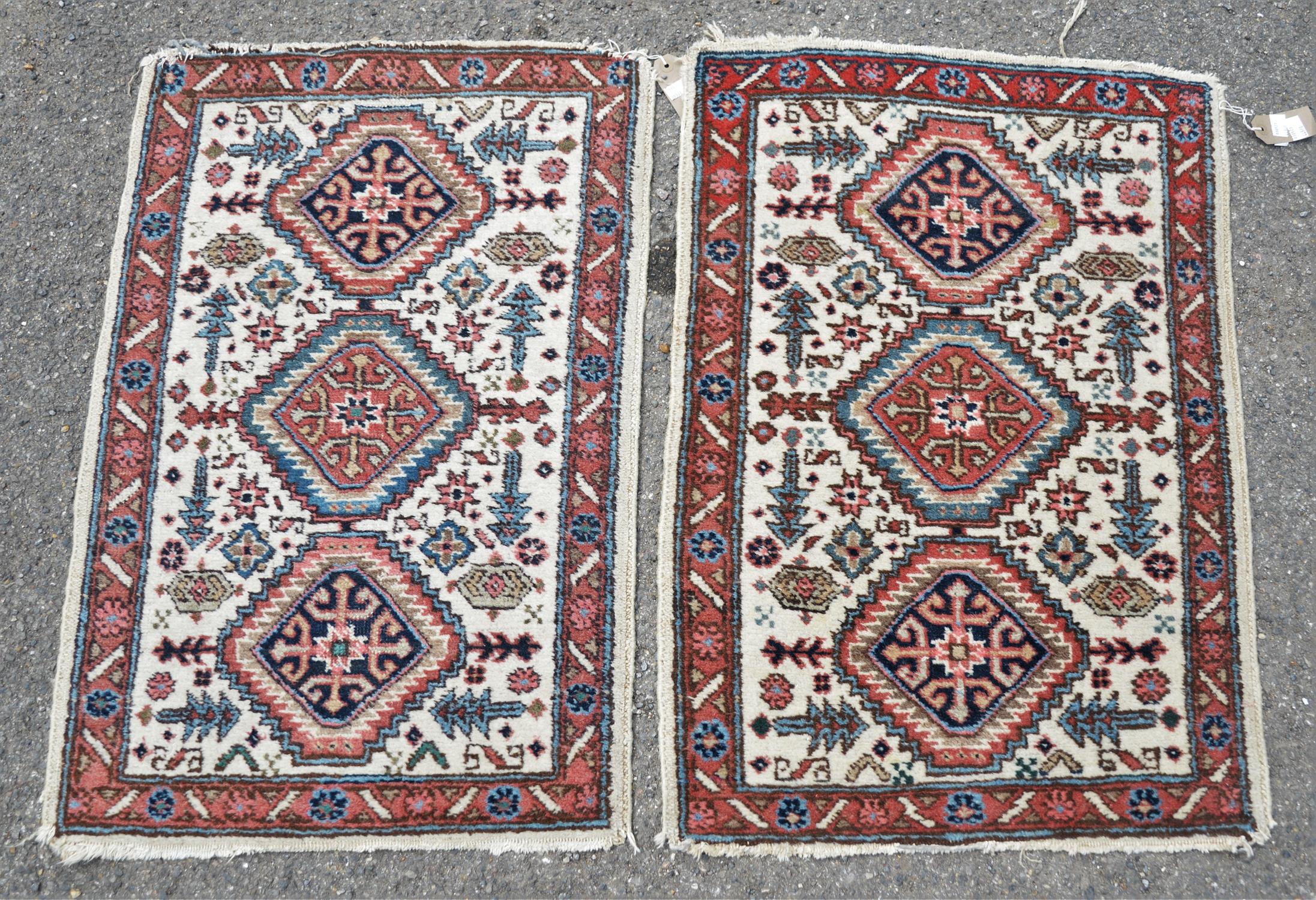 Pair of Persian carpets, 20th Century, with three lozenges, of stylised flower and cream ground,