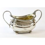 George III two handled sugar bowl, on four pad feet with gadrooned boarder marks rubbed, 8.5oz 265gm