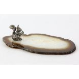 Desk ornament set as a cast silver model of a squirrel eating a nut sat on a geode slice,