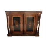 A walnut side cupboard, 19th Century with earlier elements, the two panelled doors inlaid with urn