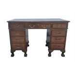 An Edwardian mahogany pedestal desk, with green leather writing surface, above three frieze drawers,