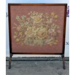 A stained wood fire screen, 20th Century, inset with a tapestry panel of a floral spray on pink