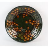 Mary Wondrausch, circular dish with foliage, signed to the base and with paper label, 30cm dia.