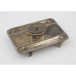 George V rectangular silver standish the central oval inkwell with glass bottle, by Lambert & Co,