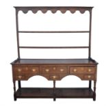 An oak dresser, 19th century, with a two shelf pot rack, the base with rectangular top,