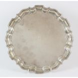 Silver salver with pie crust border on scroll feet engraved with the letter P, by Thomas Bradbury