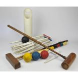 A croquet set, to comprise six cast iron hoops and a smaller marker, all with moulded marks for