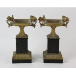 A pair of French gilt bronze and black marble tazza, 19th Century, each with handles in the form of