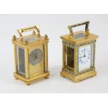 A brass cased carriage clock, inset with panels of floral enamel, the white enamel dial with blue