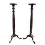 Pair of early 20th century mahogany torcheres on tripod bases with claw and ball feet, H162cms