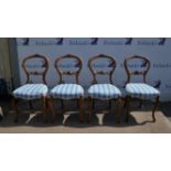 Four Victorian walnut balloon back chairs, with carved crossed C form top rails and conforming back