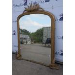 A gilt framed over mantle mirror.