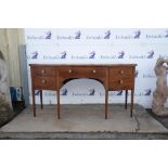 A George III mahogany bowfront sideboard, with line and banded top, with central drawer,