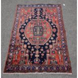 Hamadan carpet, with central octagonal medallion, stylised flowers on a brick red field,