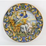 A Large Majolica charger, decorated to the centre with figures with a dog, surrounded by foliate
