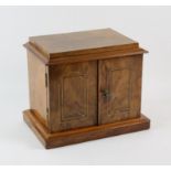 A Victorian walnut table cabinet, with two doors, enclosing drawers with two brass handles,